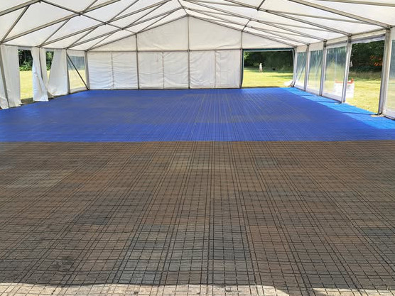 Temporary event flooring stacked on grass